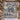 Blue Cream Nativity woven blanket displayed outdoors in a snowy courtyard with string lights