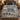 Blue Cream Nativity woven blanket spread on a bed with navy pillows