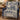 Blue Cream Nativity woven blanket draped over a navy armchair