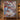 Personalized Blue Willow Pheasant Christmas quilt with custom family name hung on a wall above a bench with matching pillowcases
