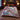 Blue Willow Pheasant Christmas woven blanket spread across a bed in a Christmas bedroom