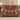 Burgundy Cardinal Bell Garden woven blanket draped over a sofa in a holiday living room