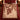 Burgundy Ivory Nutcracker woven blanket spread on a bed with burgundy bedding