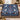 Personalized Celestial Blue Christmas Grove woven blanket with custom family name draped over a sofa by a Christmas tree