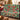Ceramic Christmas Tree Squirrels woven blanket draped over a sofa in a holiday living room
