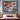 Christmas Bell Garden Cardinal woven blanket displayed as a wall tapestry above a bed