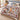 Christmas Dogs Poinsettia woven blanket spread across a bed in a bright bedroom