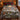 Reindeer in a snowy spruce forest woven blanket spread on a bed in a log cabin bedroom