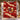 Christmas Pudding Supper woven blanket displayed on a snowy front porch with Christmas garland and lanterns