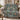 Christmas Rose Medallion woven blanket draped over a cream armchair