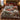 Vintage red pickup and red barn woven blanket spread on a bed