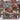 Christmas Tree Farm Red Truck woven blanket displayed outdoors on a snowy fence by a red barn