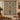 Christmas Tree of Life woven blanket displayed as a holiday wall tapestry above a candlelit table