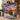 Couple holding a personalized Christmas tree ship woven blanket with custom name woven in