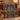 Circling Koi Maple Medallion woven blanket draped over a red sofa