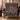Circling Koi Maple Medallion woven blanket draped over a navy armchair