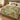 Copper Fox Fernwood woven blanket spread on a bed