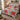Crimson Solstice Poinsettia quilt bedding set with 2 matching pillowcases on a bed in a cozy bedroom