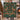 Couple holding a personalized Deer and Cardinal Christmas Tree woven blanket with custom family name woven in