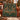 Deer and Cardinal Christmas Tree woven blanket draped over a rust velvet sofa