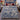 Blue and white amaryllis floral woven blanket spread on a bed