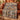 Denim Terracotta Balloon Valley Pattern woven blanket draped over a rust sofa