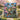 Enchanted Garden Anime woven blanket displayed on a garden bench among cherry blossoms