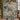 Couple holding a personalized Evergreen Reindeer Herd woven blanket with custom names beside a Christmas tree
