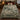 Green and cream reindeer forest pattern woven blanket spread on a bed