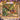 Personalized Fig Harvest & Butterfly Garden woven blanket with custom name shown in a flowering garden