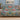 Four Kingfishers Waterlily Garden woven blanket draped over a sofa in a living room