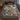 Frosted Christmas Rose Garden woven blanket spread on a bed with red and green pillows