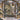 Frosted Christmas Rose Garden woven blanket displayed on a snowy wrought-iron garden gate with a wreath