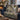 Frosted Christmas Rose Garden woven blanket draped over a navy sofa beside a lit fireplace