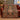 Red and green gingerbread patchwork woven blanket draped over a red sofa