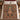 Gingerbread Christmas Patchwork woven blanket spread on a bed with cream pillows