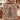 Couple holding a personalized gingerbread Christmas tree woven blanket with custom family name woven in
