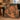 Gingerbread Icing Village woven blanket draped over a green velvet sofa