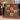 Red green and sage gingerbread cookie woven blanket draped over a navy sofa