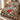 Glasshouse Poinsettia Noel quilt bedding set with 2 matching pillowcases on a made bed
