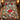 Glasshouse Poinsettia Noel duvet cover set with 2 matching pillowcases on a bed in a cozy Christmas bedroom