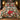 Glasshouse Poinsettia Noel comforter set with 2 matching pillowcases on a bed in a warm bedroom