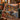 Golden Hour Tamarack Moose Lake woven blanket draped over a green sofa by a lake view window