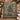 Green Cream Woodland Christmas woven blanket draped over a staircase banister with garland