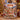 Woman holding a personalized Grinchmas snowy village fleece blanket with custom family name in a Christmas living room