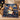 Hamilton Schuyler Sisters Christmas woven blanket draped over a beige sofa