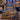 Hanukkah Eighth Night Window woven blanket draped over a navy armchair by a window with a lit menorah