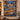 Hanukkah Eighth Night Window woven blanket displayed as a wall tapestry on a stone wall above a menorah