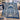 Hanukkah Papercut Menorah fleece blanket draped over a cream sofa with blue pillows