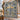 Hanukkah Tree of Light woven blanket draped over a staircase banister with an olive garland